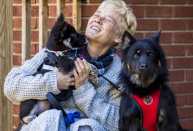 A very happy Christina Kennis with her dogs Chloe and pup Bella, who recently returned from Cuba.