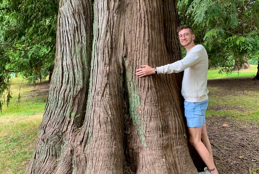 Sam Thompson, creator of Sam Co. Creations, says his hugging a tree is fitting since the products he creates centre around recycling. Contributed