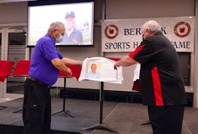 Berwick Sports Hall of Fame committee member Bruce Redden, right, helped Levi Sherman unveil his plaque. Sherman was a member of the Cambridge Tigers provincial softball champions and a member of the Cambridge Red and Whites 1967 Maritime Softball champions.