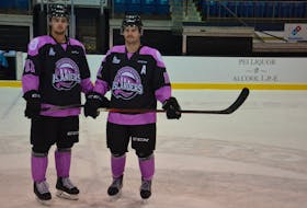Charlottetown Islanders defenceman Lukas Cormier, left, and forward Xavier Simoneau pose in the specially-designed jerseys the Quebec Major Junior Hockey League team will wear against the Quebec Remparts in the Hockey Fights Cancer night at Eastlink Centre on Nov. 26. Fans can bid in an online auction to win Cormier’s and Simoneau’s game-worn jerseys. That auction is open now until 9 p.m., on Nov. 26. 