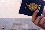  Safwan Al-Kanadi, a.k.a. Sami Elabi, shows his passport to the camera before lighting it on fire and shooting it in an image from an ISIL propaganda video.