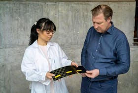 Doctor Johanna Xu, left, with a newly manufactured structural battery cell in Chalmers’ composite lab, which she shows to Leif Asp. Marcus Folino photo/Chalmers University of Technology