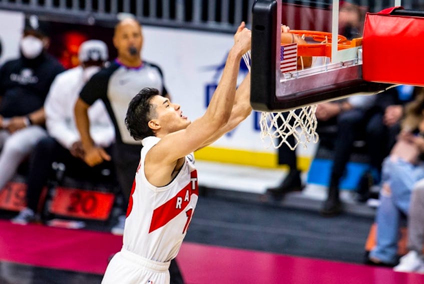 The Raptors' Yuta Watanabe dunks during a game in Cleveland on April 10. For the first time in his career, Watanabe showed up to practice on Tuesday with a standard NBA contract.