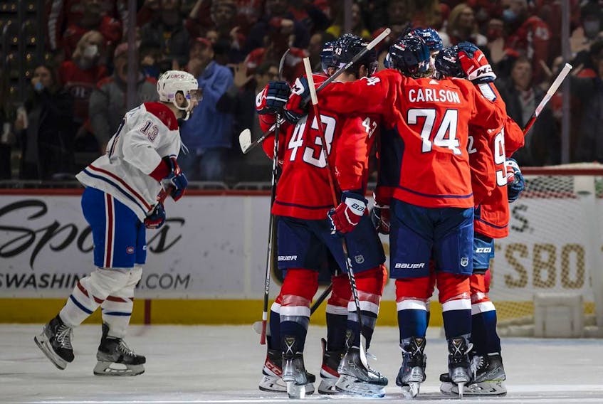 Capitals players celebrate after scoring first-period goal while the Canadiens’ Cédric Paquette skates past during game Wednesday night in Washington. Capitals won the game 6-3.