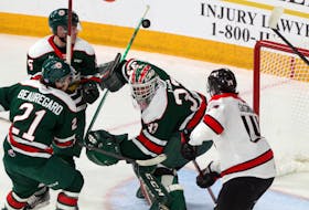 Nov. 26, 2021--Mooseheads' Zachary Beauregard, Brady Schultz and goaltender Brady James, with Rouyn-Noranda Huskies' Mathieu Gagnon try to follow the flying puck during a play late in the first period.
ERIC WYNNE/Chronicle Herald