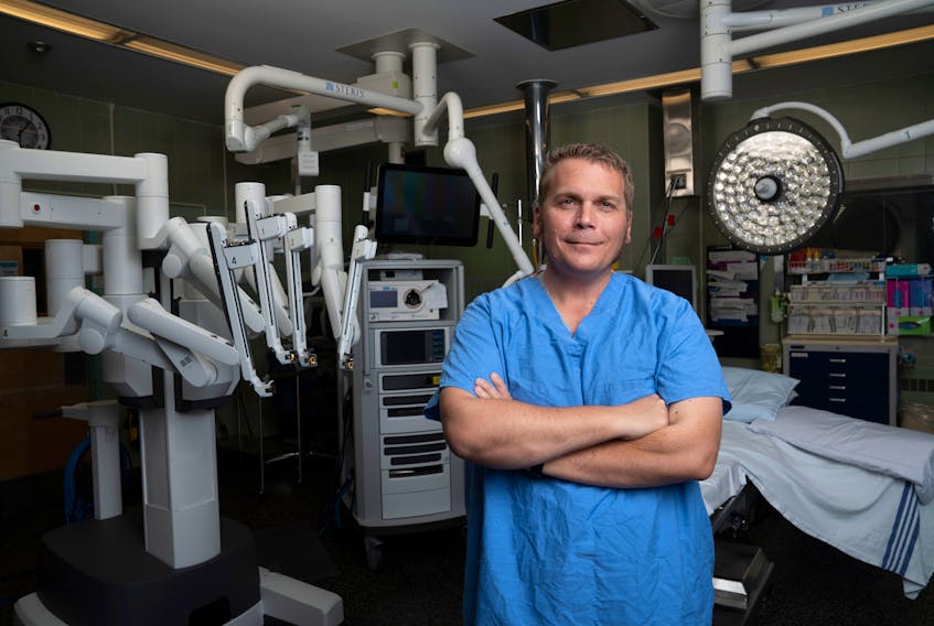 Warren Connors pictured with the QEII’s da Vinci robot for cancer surgeries, which he credits for saving his life. Today, the kidney cancer survivor is a champion for the expansion of surgical robotics to other care areas, like orthopaedics. Photo Courtesy QEII Foundation.
