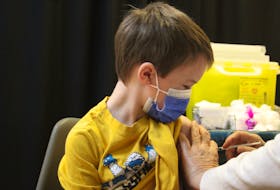 Hudson Holmes, 7, was one of the children who showed up to the vaccination clinic at the County Fair Mall for his first dose of the COVID-19 vaccine. Friday, Nov. 26, was the first day in P.E.I. that kids between the ages of five and 11 were eligible to be vaccinated. Hudson's mother, Becky Holmes, said she was "a little unsure, but I think this is the right direction to go at this point." Her son, she said, was relieved to finally get his vaccination.