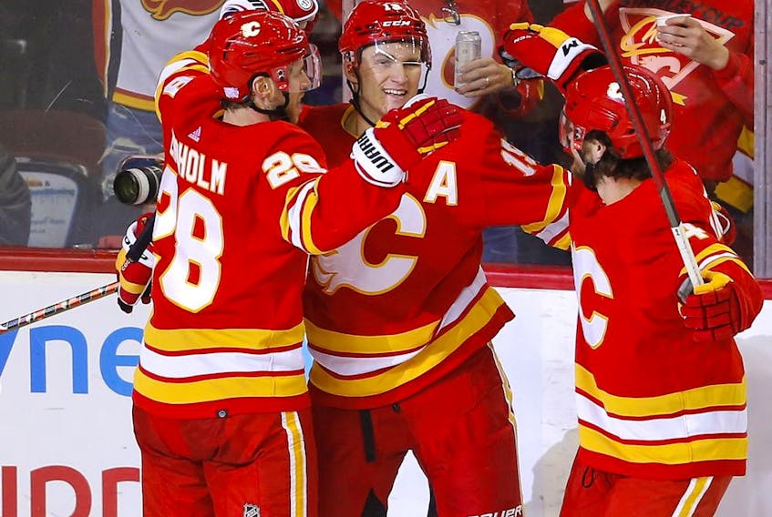 The Calgary Flames’ Matthew Tkachuk celebrates after scoring the game-winner against the Chicago Blackhawks goalie Marc-Andre Fleury at the Scotiabank Saddledome in Calgary on Tuesday, Nov. 23, 2021.