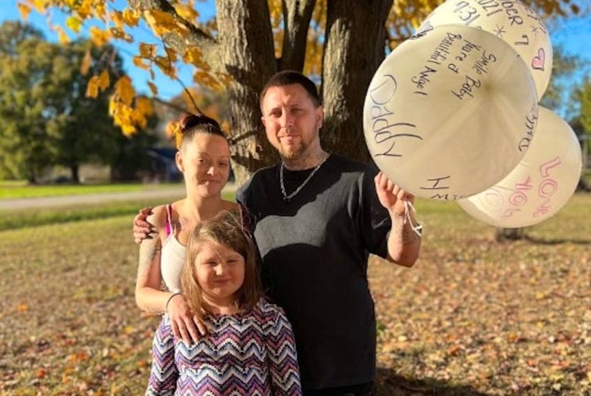Christa McNeil and Bobby Wallace Jr. get ready to release balloons with their daughter MacKenzie as a memorial to their "angel," Harmony Grace Wallace.