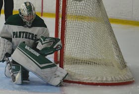 UPEI Panthers goaltender Camille Scherger makes a glove save in a 1-0 victory over the UNB Reds in an Atlantic University Sport women’s hockey game at MacLauchlan Arena on Nov. 21. Scherger initiated Saves for Mental Health for the 2021-22 season. It’s a program where local businesses and sponsors donate $1 for every save made by goaltenders with the UPEI women’s hockey team.