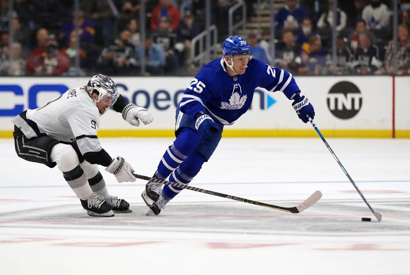 Toronto Maple Leafs right winger Ondrej Kase controls the puck past Los Angeles Kings' Adrian Kempe.