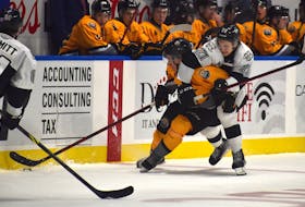 Cape Breton Eagles forward Émile Hegarty-Aubin, left, skates with the puck in the neutral zone as he ties up with Anri Ravinskis of the Blainville-Boisbriand Armada during Quebec Major Junior Hockey League action at Centre 200 on Friday. The Armada won the game 7-1. JEREMY FRASER/CAPE BRETON POST