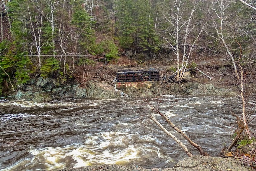 Gordon Crimp of Tarbotvale attached a rope to a rock and threw it across the Barachois River, where the 30-metre Tarbotvale Bridge once, so that medication and other supplies could be delivered across the river.  Photo submitted by Beverly Brett.