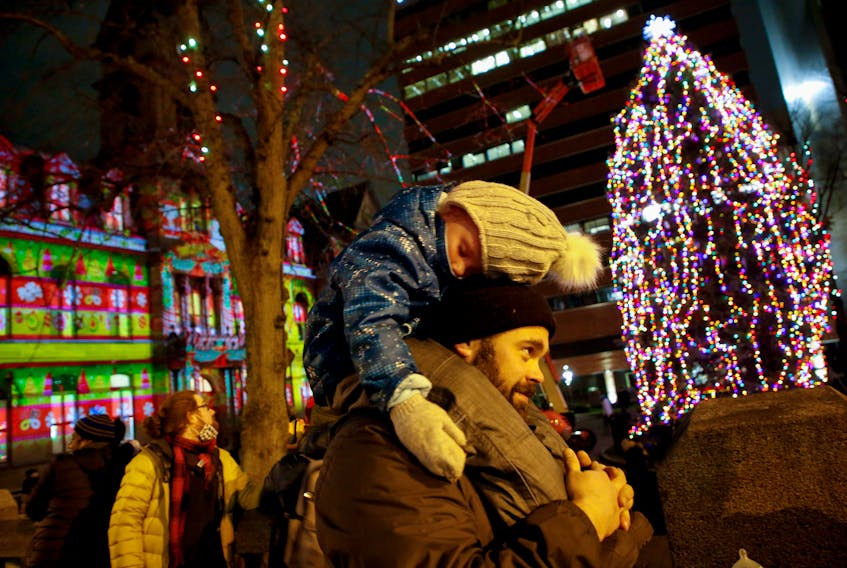 FOR NEWS STANDALONE:
Ryan McDonald holds his snoozing daughter, Rachelle, 4, following the lighting of the city Christmas tree in the Grand Parade in Halifax Saturday evening November 27, 2021. The McDonald family brought 3 children, 2 of whom were too sleepy, and managed to sleep through the fireworks and the lighting.

TIM KROCHAK PHOTO