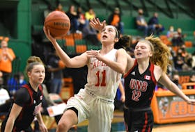 Capers' MacKenzee Ryan looks for a scoring opportunity against UNB Reds' McKinley Bezanson in AUS women's basketball action on Saturday at Sullivan Field House. VAUGHAN MERCHANT • CBU ATHLETICS