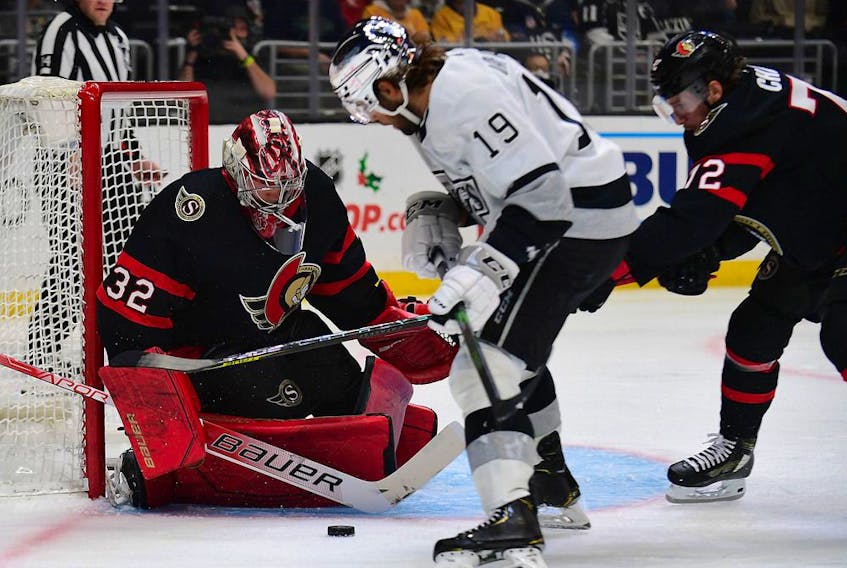 Senators defenceman Thomas Chabot (72) helps goaltender Filip Gustavsson defend the goal against Kings right-winger Alex Iafallo during the second period of Saturday's game.