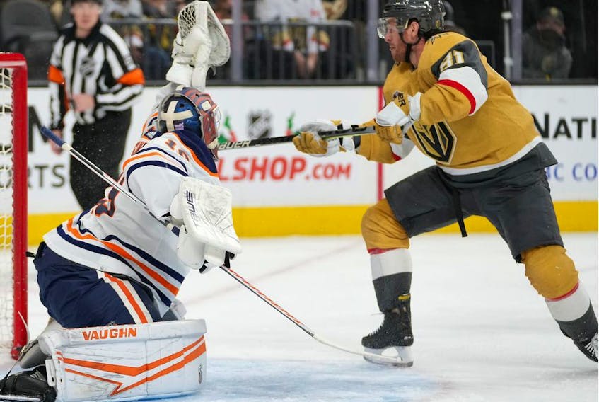 Edmonton Oilers goaltender Mikko Koskinen (19) makes a glove save as Vegas Golden Knights center Jonathan Marchessault (81) looks to deflect the puck during the first period at T-Mobile Arena. 