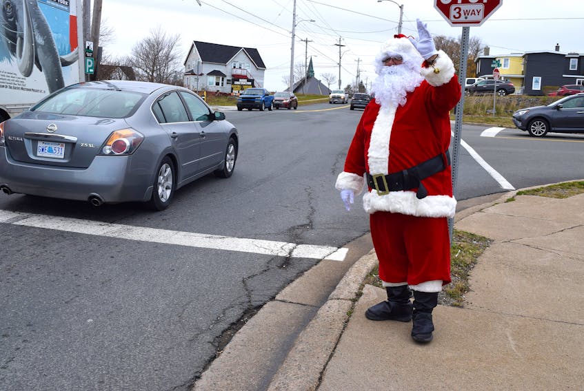Santa Claus has fun greeting motorists in Glace Bay. Blaine Saccary, of Glace Bay, said he always wanted to fill the big guy’s boots and is living a dream. Sharon Montgomery-Dupe/Cape Breton Post