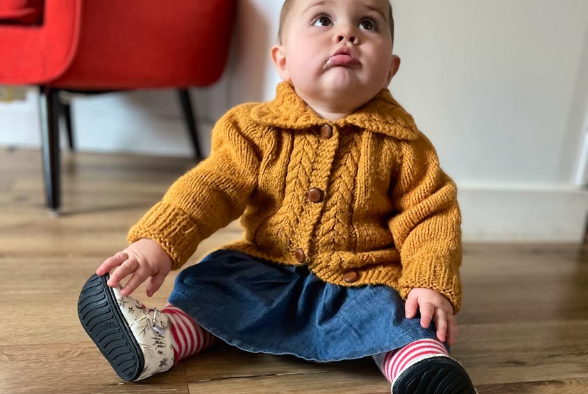 Nine-month-old Iris Rice in the wool sweater her grandmother Sandra Rice knit when she was 18, which made its way back to the Sydney Mines family even though it was passed through many families and at least one thrift store.