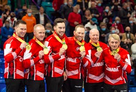Members of the Brad Gushue-skipped rink from St. John's, (from left) Gushue, third Mark Nichols, second Brett Gallant, lead Geoff Walker, alternate Jeff Thomas and coach Jules Owchar, show off their medals after winning the Tim Hortons Trials Canadian Olympic qualifying event Sunday in Saskatoon, — Curling Canada photo/Michale Burns