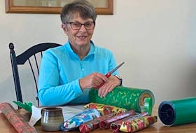 Caremonger Sheila Porter eagerly volunteered to help wrap Christmas gifts for seniors.