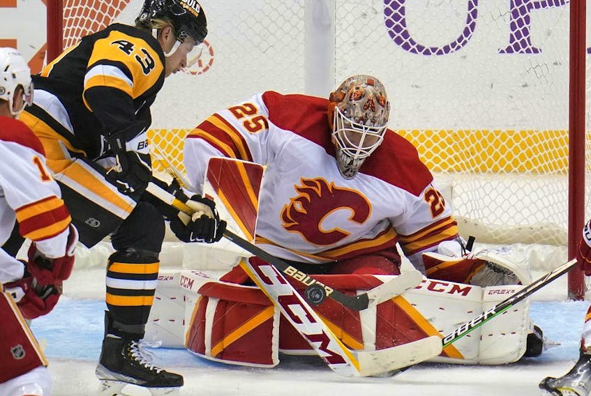 Calgary Flames goaltender Jacob Markstrom blocks a shot by the Pittsburgh Penguins’ Danton Heinen at PPG Paints Arena in Pittsburgh on Oct. 28, 2021.