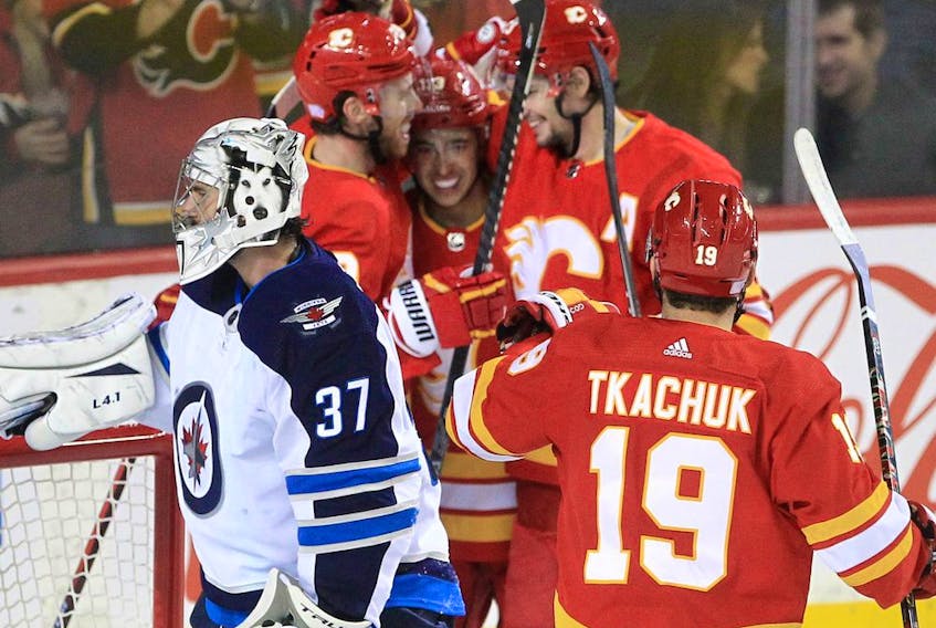 The Calgary Flames celebrate a goal from Elias Lindholm agains the Winnipeg Jets at the Saddledome in Calgary on Saturday, Nov. 27, 2021.