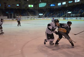 The Blainville-Boisbriand Armada’s Colby Huggan, 72, battles for position with the Charlottetown Islanders’ Oscar Plandowski during second-period action of a Quebec Major Junior Hockey League game at Eastlink Centre on Nov. 28. Huggan, from Charlottetown, is in his rookie season with the Armada, who played their only game of the regular season at Eastlink Centre.