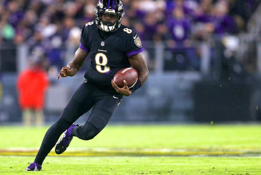 Ravens quarterback Lamar Jackson runs with the ball against the Browns at M&amp;T Bank Stadium in Baltimore, Sunday, Nov. 28, 2021.
