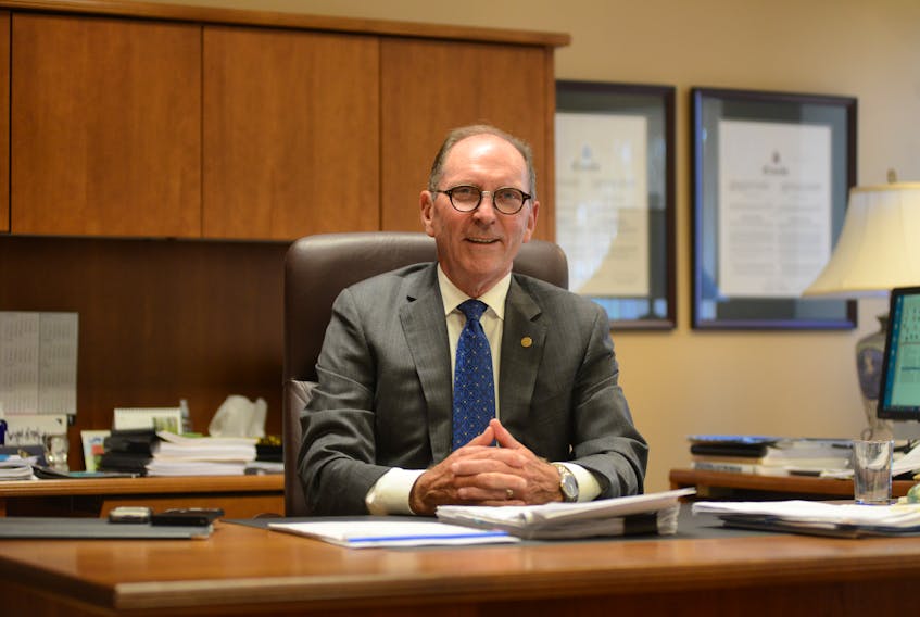 Former P.E.I. Court of Appeal Chief Justice David Jenkins sits at his desk ahead of his recent retirement after serving 28 years as a judge, including 13 years on the province's Court of Appeal. 