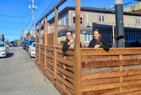 Danielle Casagrande and Michelle Wilson of the Downtown Sydney Association stand on one of four recently-erected wooden patios on Charlotte Street. The association received a $50,000 grant from the Nova Scotia Business and Labour Economic Coalition through its “placemaking” program that is part of its tactical recovery plan. DAVID JALA • CAPE BRETON POST