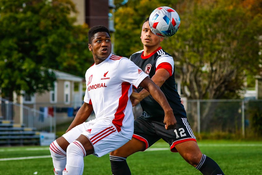 In this file photo from early October, Memorial Sea-Hawks striker Emmanuel Dolo (10) tracks the ball as he is shadowed by Matt Boem of the University of New Brunswick Reds during an AUS men's soccer game at King George V Park in St. John's. The Sea-Hawks and Dolo, who was named a first-team AUS all-star on Wednesday, will meet up again with Boem and the Reds Thursday night in the opening round of the AUS men's soccer championship tournament hosted by the Cape Breton Capers. — Memorial Athletics photo/Ally Wragg