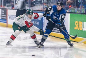 Halifax Mooseheads captain Elliot Desnoyers plays defence against Saint John Sea Dogs forward Cam MacDonald during Tuesday’s QMJHL game in Saint John.