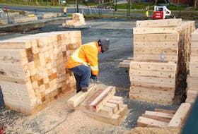 Construction crews preparing the site for an emergency housing modular unit project at the site of a former parking lot off of Alderney Drive in Dartmouth on Tuesday, Nov. 30, 2021.