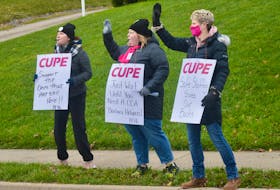Megan Woodfine, from left, Kayla MacPherson and Michelle Bennett wave to passing motorists during CUPE’s “Day of Action” rally in front of the Northside Community Guest Home on Tuesday. The province-wide series of demonstrations were held to draw attention to serious problems identified by nursing home workers. DAVID JALA/CAPE BRETON POST