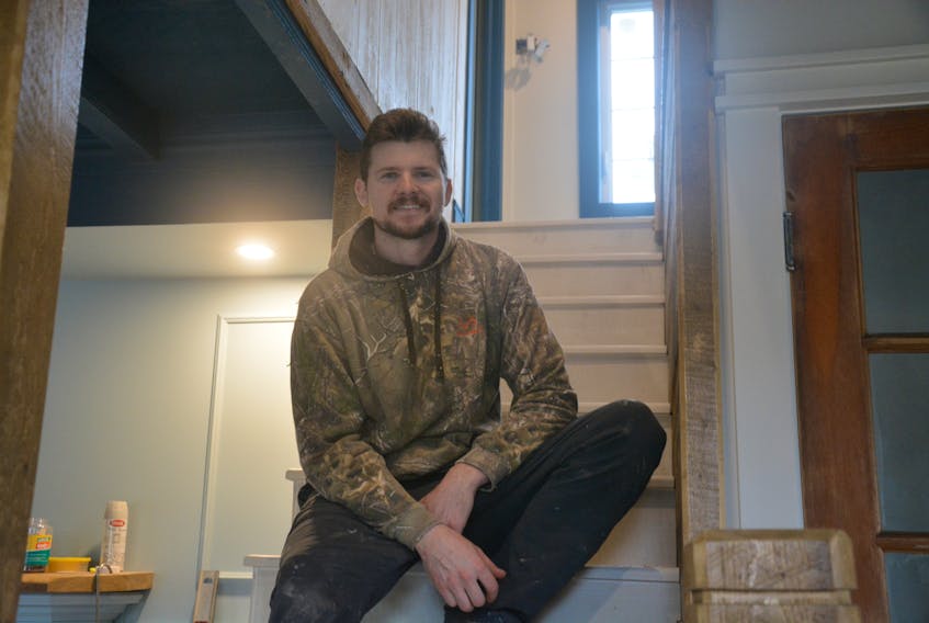 Walter Lynch sits in the middle of his nearly restored Brigus biscuit box home. He anticipates only two more weeks before the home is finished. 