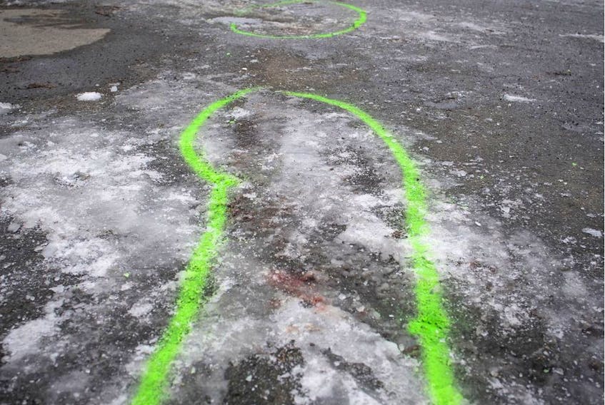 Police markings outline an area where blood stains mark the spot of a stabbing in Marc Aurèle Fortin Park north of Montreal on Thursday, Jan. 2, 2020.