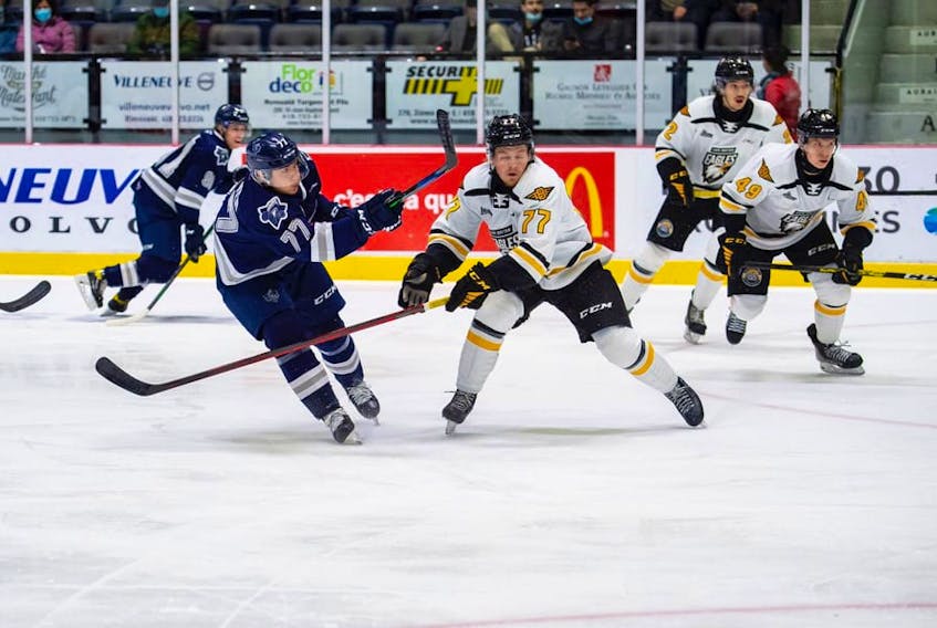 Alex Drover of the Rimouski Océanic fires a shot on goal as Conor Shortall of the Cape Breton Eagles attempts to block the shot during Quebec Major Junior Hockey League action at Colisée Financière Sun Life in Rimouski, Que., Wednesday. Rimouski won the game 5-4. PHOTO CONTRIBUTED/RIMOUSKI OCEANIC.
