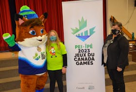 Island artist Noella Moore, right, and Myla Doucette meet Wowkwis, the mascot for the 2023 Canada Winter Games that will take place on P.E.I. Myla won a provincewide design competition for the mascot last spring. Moore designed the quillwork that Wowkwis wears as a medal.