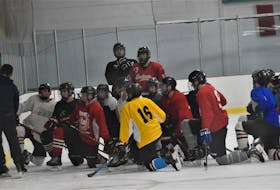 The Pictou County Jr. B. Scotians listening to instructions from coach Cole Baker at a recent practice in Trenton.    