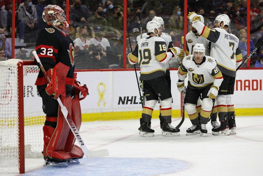 Senators goaltender Filip Gustavsson looks on as Vegas Golden Knights' Jonathan Marchessault (81) and his teammates celebrate his goal during second period NHL action at the Canadian Tire Centre on November 4,2021.  