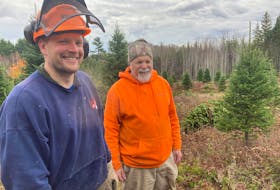 Donnelly Archibald and his father, Brian, at their Christmas tree lot behind Fishers Mills.