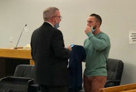 Noel Strapp (right) speaks with his lawyer, Ian Patey, in provincial court in St. John's on Nov. 2, 2021.