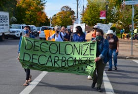 Caroline Beddoe and Christine Moreau lead the march as Fridays for Future climate crisis demonstrators make their way down Wolfville’s Main Street on Oct. 22. KIRK STARRATT