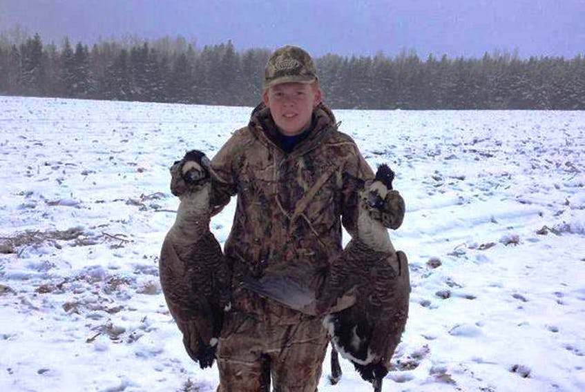Jack Gamble, a Summerside hunter, holding up two Canadian geese he had just hunted that day.