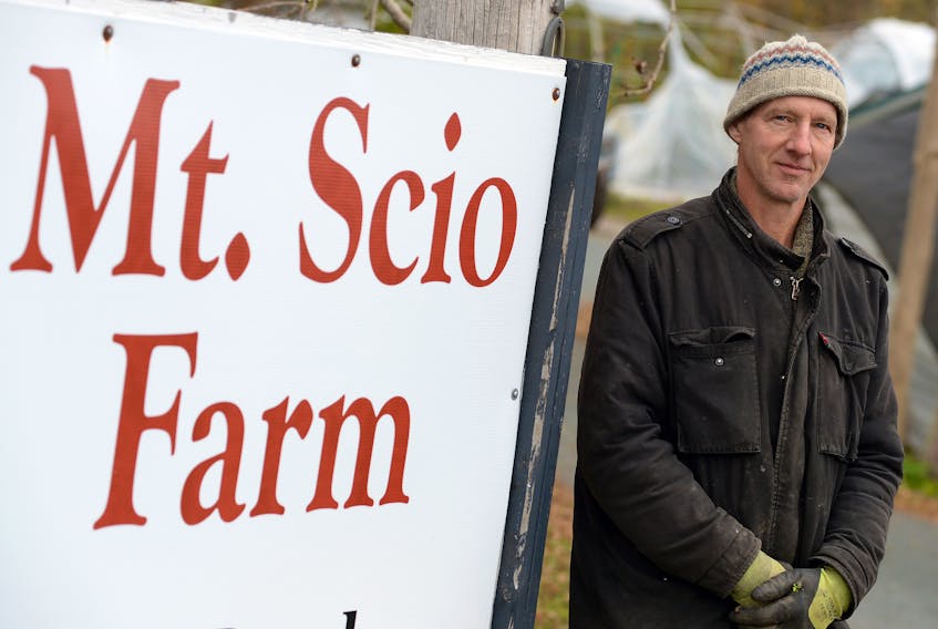 Jeremy Carter stands near the sign for the Mount Scio Farm location on Mount Scio Road Friday afternoon.

Keith Gosse/The Telegram