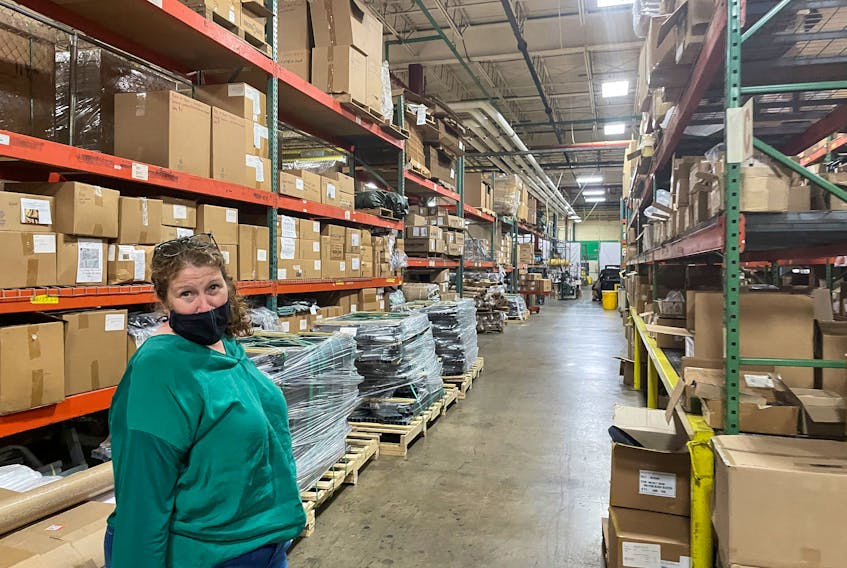 Diamond Brand COO Lauren Rash stands in an aisle of shelves with stockpiled parts as the "lean" supply management has been upended by global shortages and bottleneck Carolina.
REUTERS 