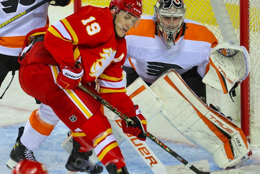  The Calgary Flames’ Matthew Tkachuk looks to redirect a puck past Philadelphia Flyers goalie Carter Hart at the Scotiabank Saddledome in Calgary on Saturday, Oct. 30, 2021.
