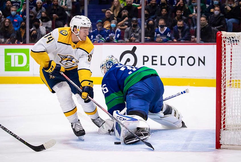  Vancouver Canucks goalie Thatcher Demko, stops Nashville Predators’ Tanner Jeannot in the first period of their game at Rogers Arena on Friday, Nov. 5, 2021.