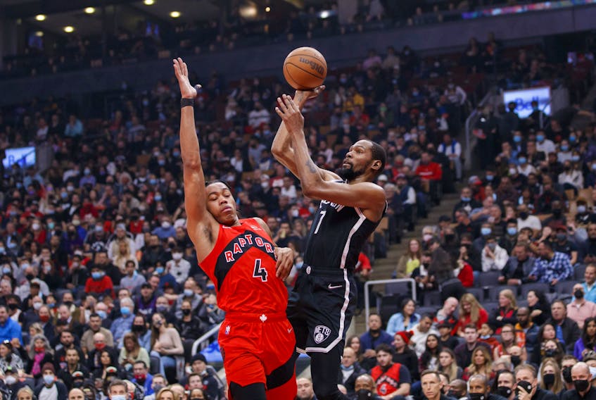  Nets’ Kevin Durant puts up a shot over Scottie Barnes of the Raptors during the first half at Scotiabank Arena on Nov. 7, 2021 in Toronto. COLE BURSTON/GETTY IMAGES